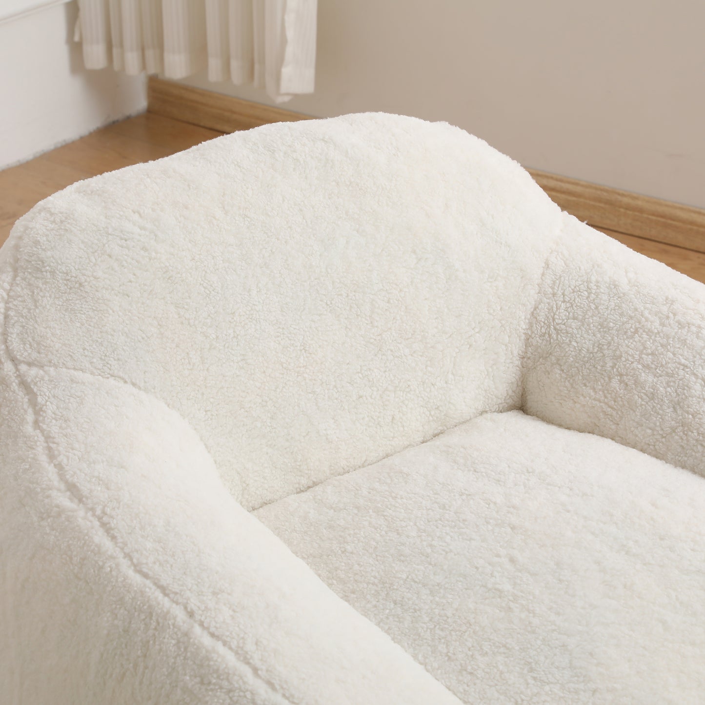 Plush white teddy fabric armchair closeup