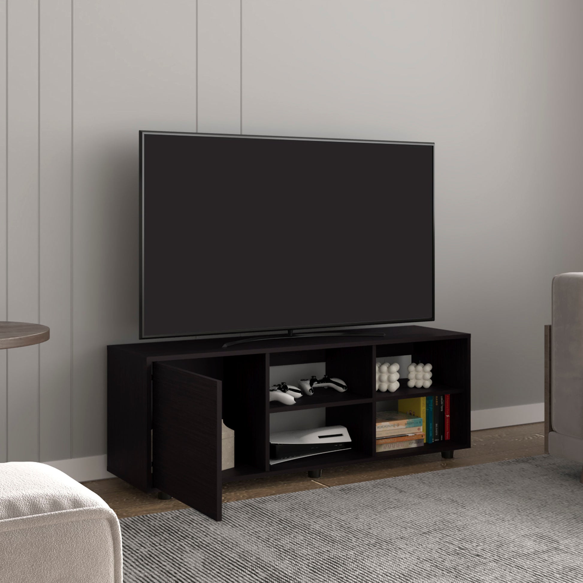 Dark espresso media console with open shelves and two doors holding gaming consoles