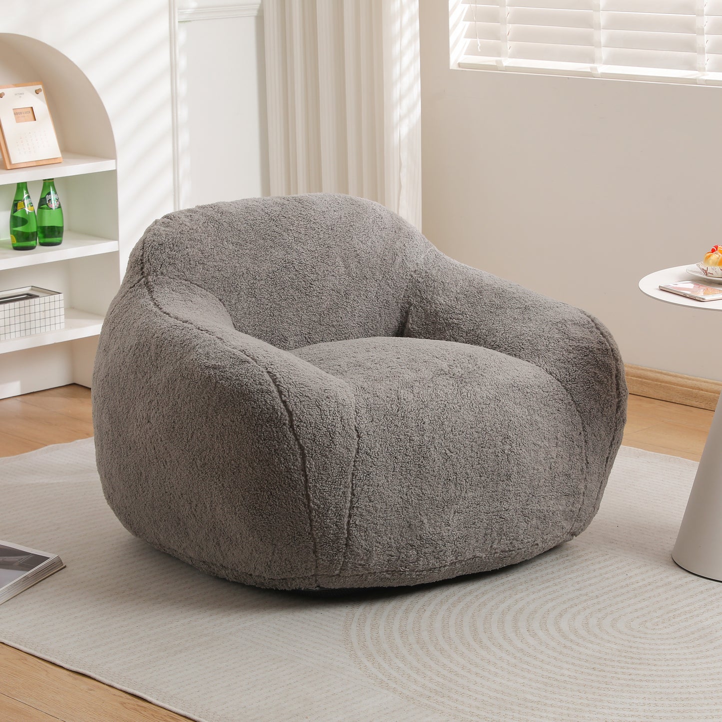 Plush grey accent chair with a rounded inviting design perfect for reading nooks
