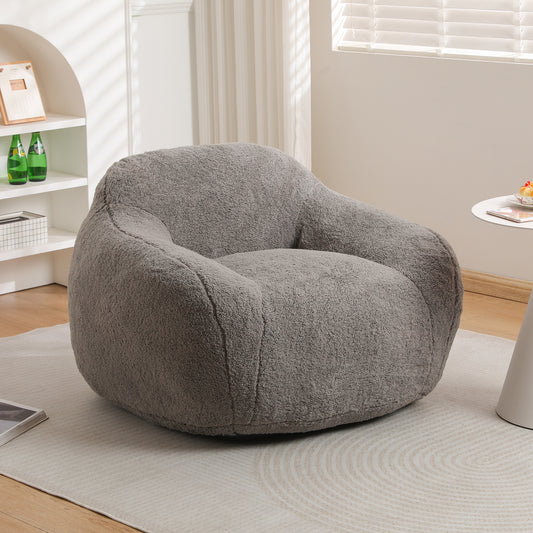 Plush grey accent chair with a rounded inviting design perfect for reading nooks