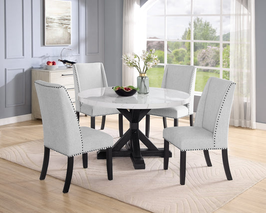 Round marble top dining table with four upholstered light grey chairs