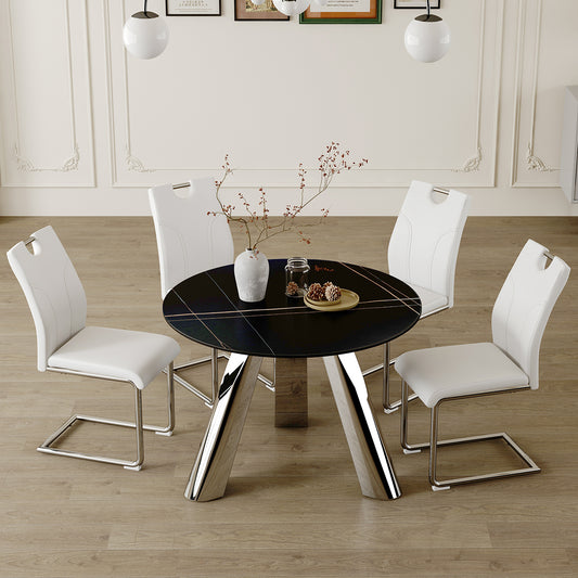 Round black dining table with chrome legs and white faux leather chairs