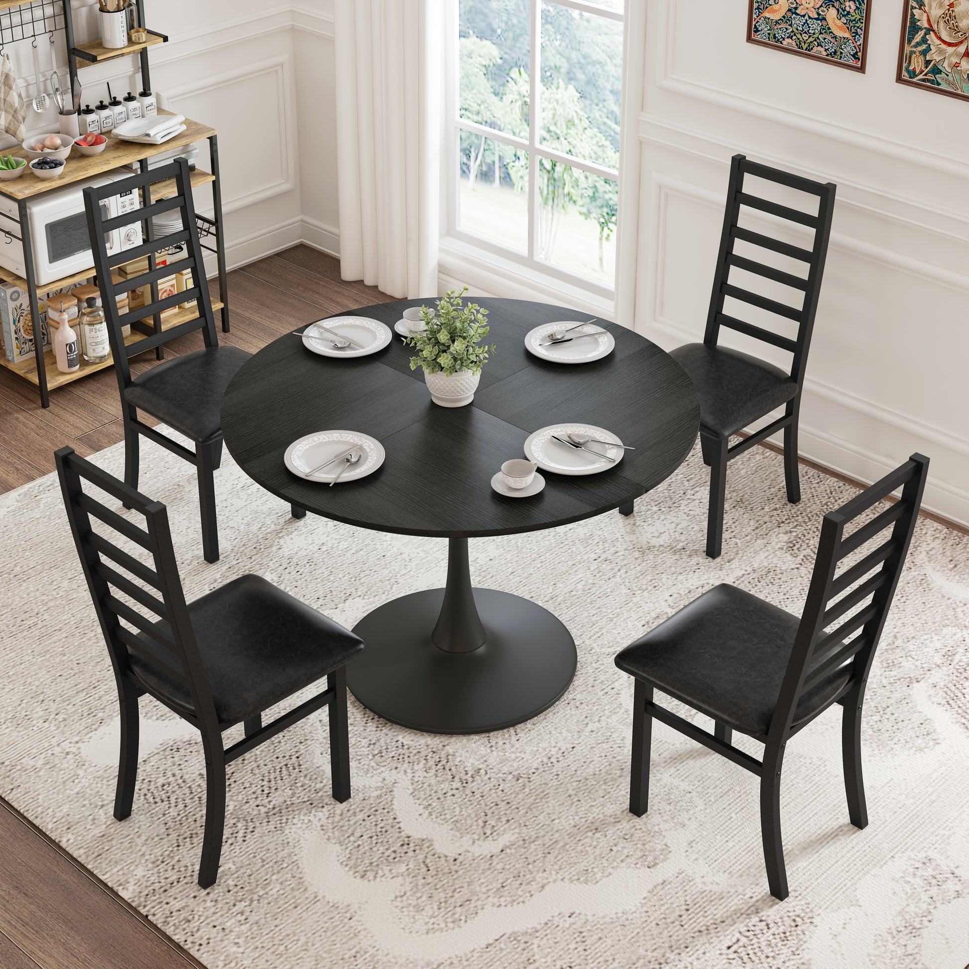 Black round dining table with four chairs on a textured rug