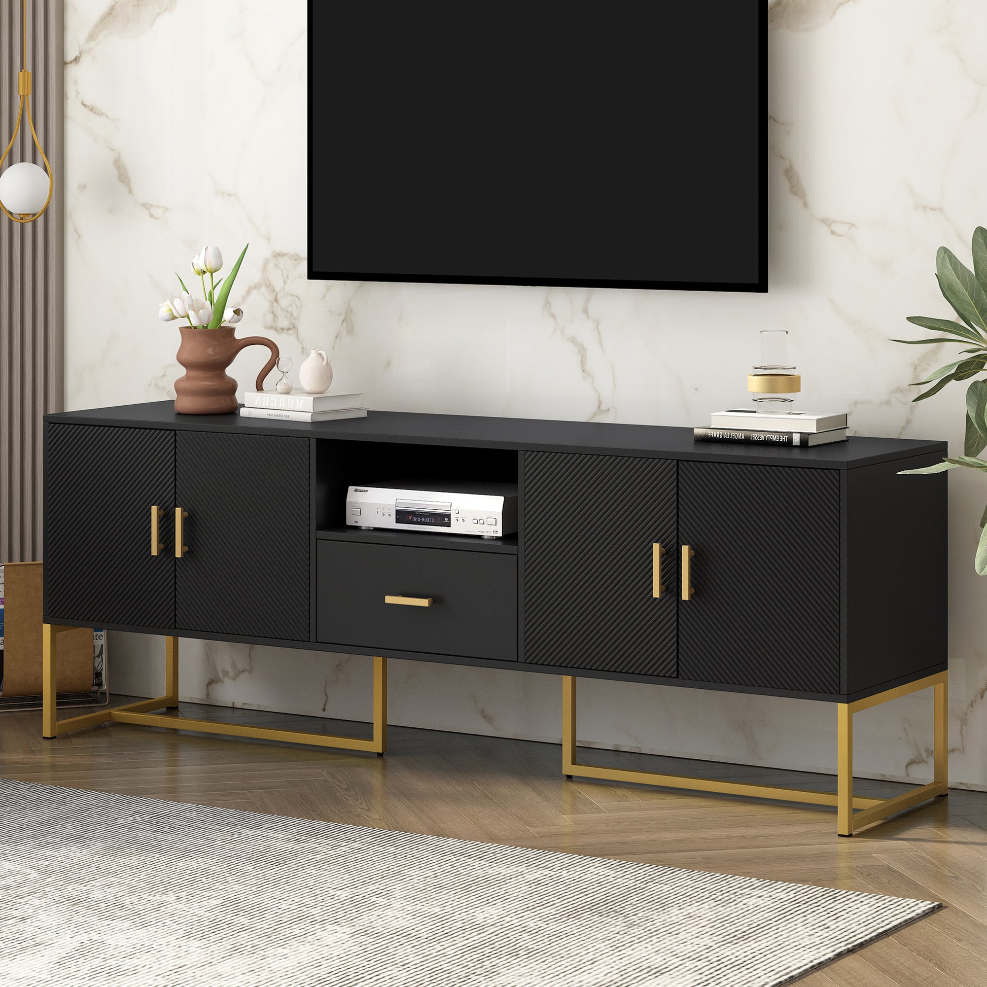 Black media console with fluted doors and gold hardware