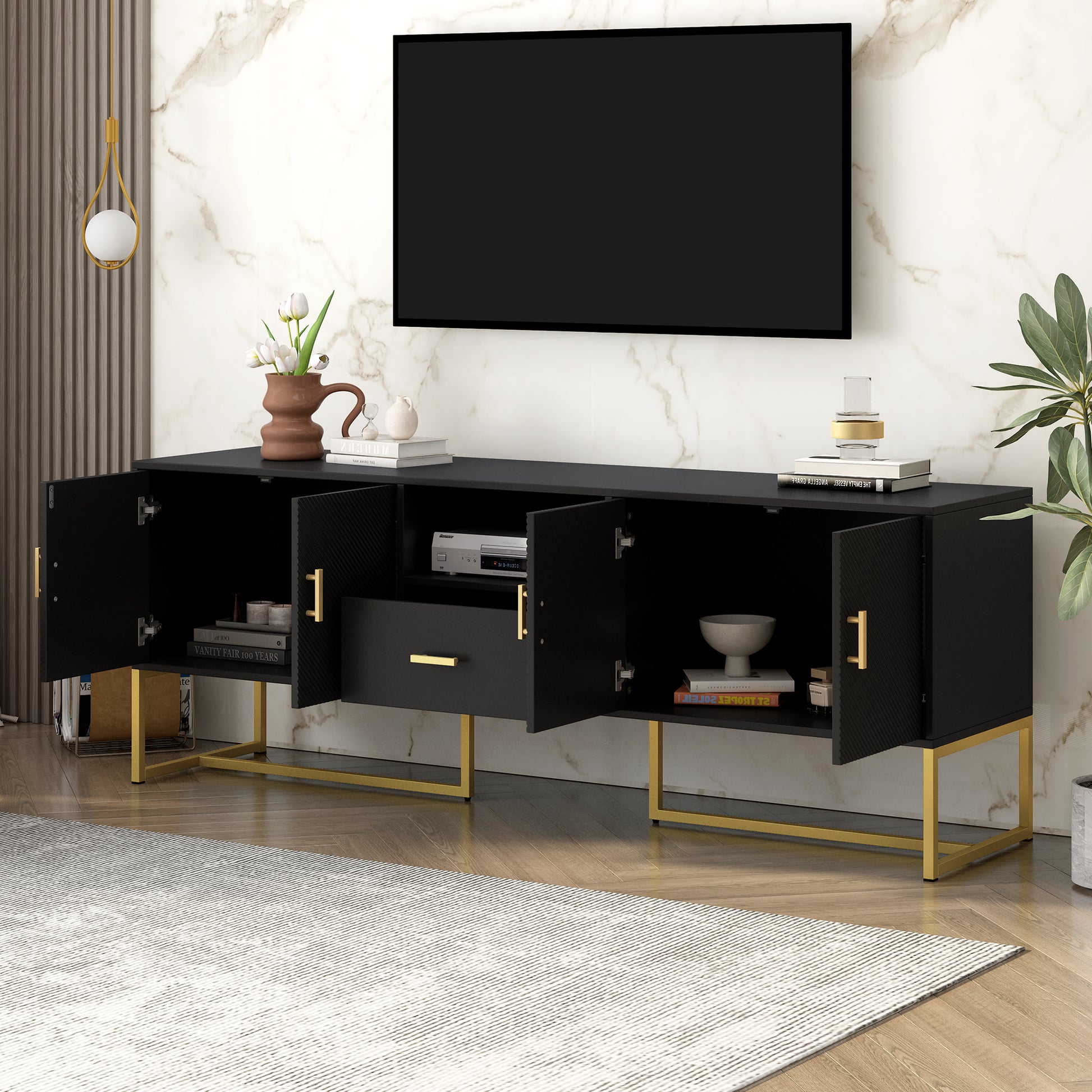 Black media console with gold legs and textured cabinet doors