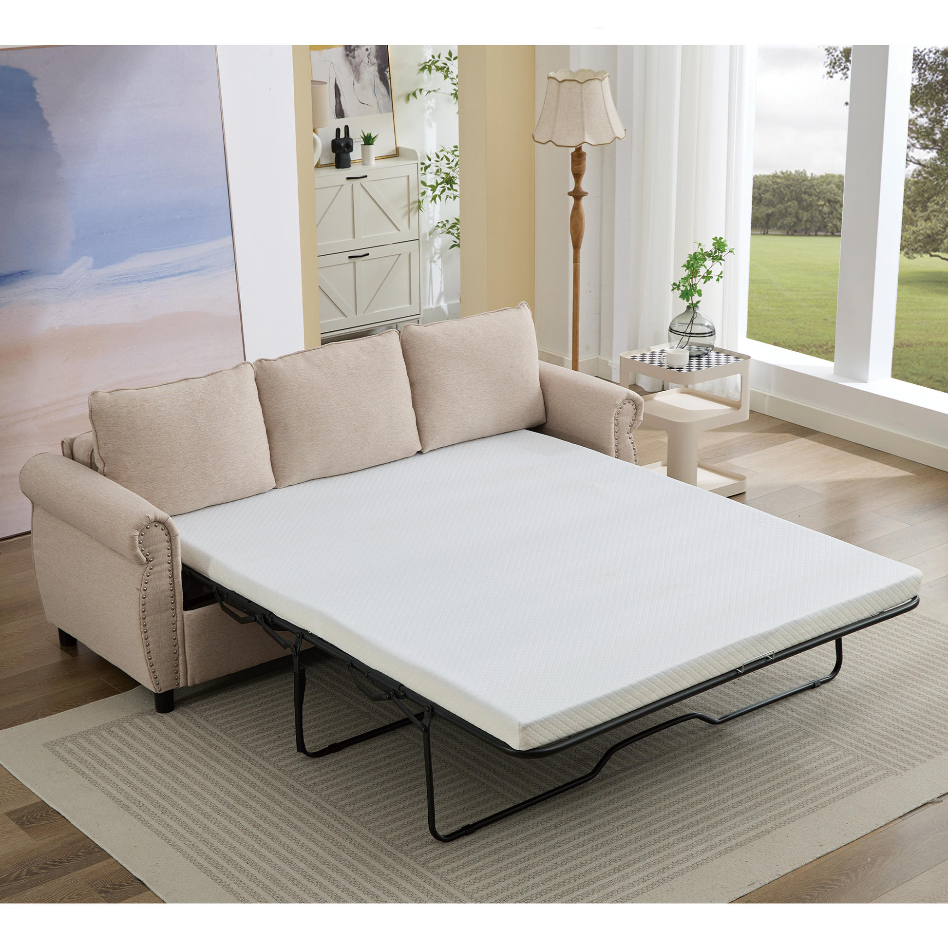 Beige fabric sofa bed with nailhead trim extended into a twin mattress for sleeping