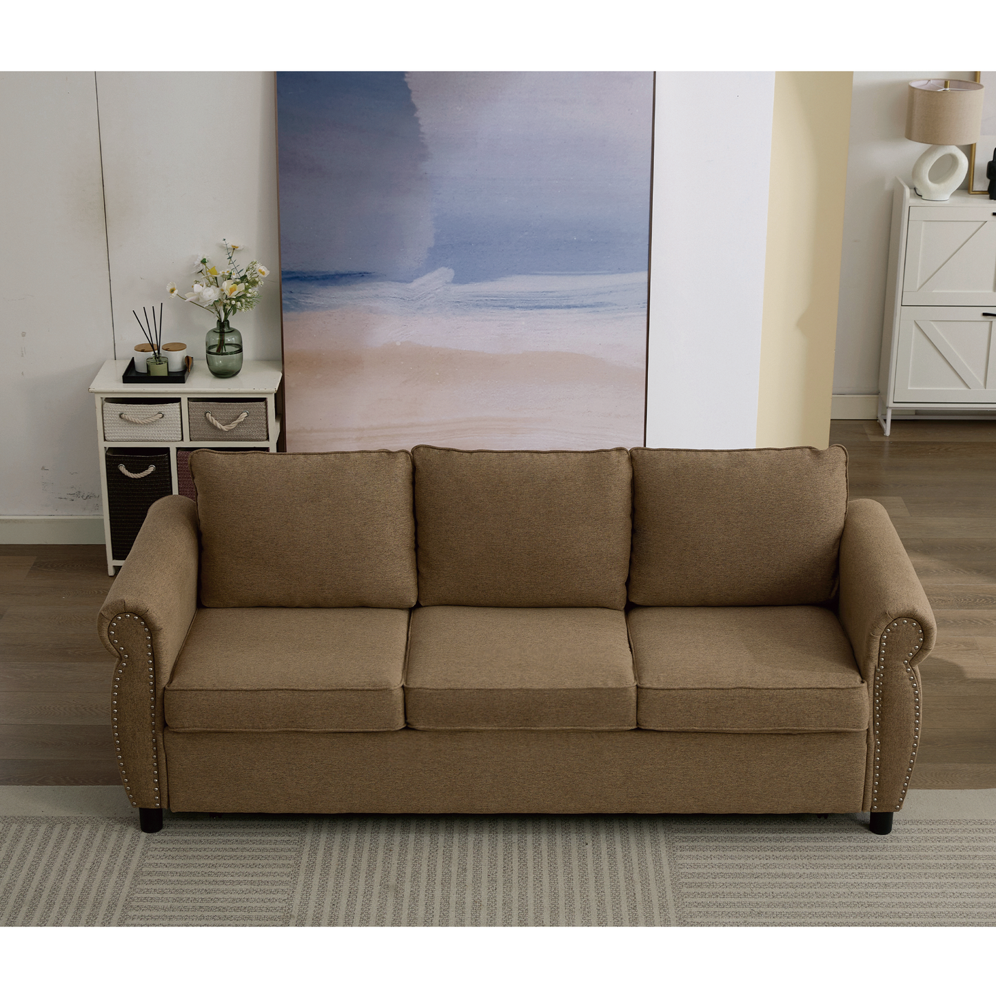 Brown fabric sofa with three cushions and nailhead trim accents