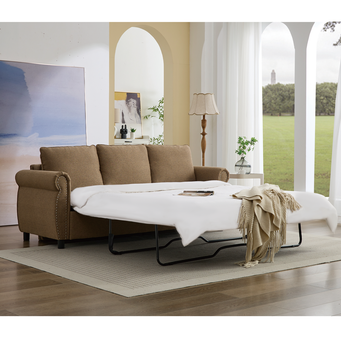 Brown upholstered sofa bed with decorative nailhead trim and pullout mattress
