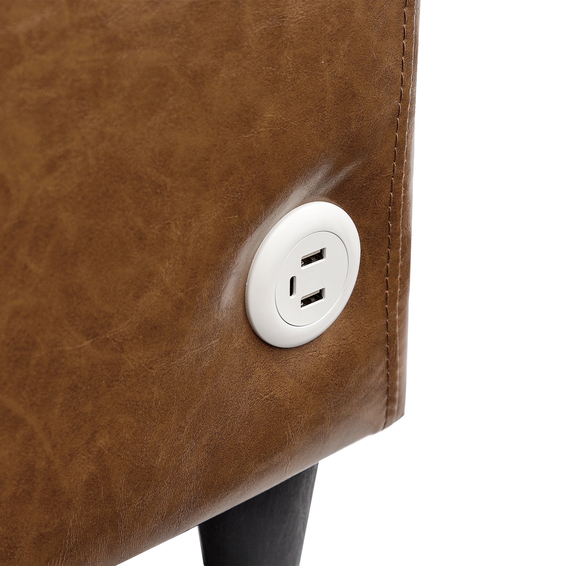Brown faux leather armchair detail with integrated USB charging port