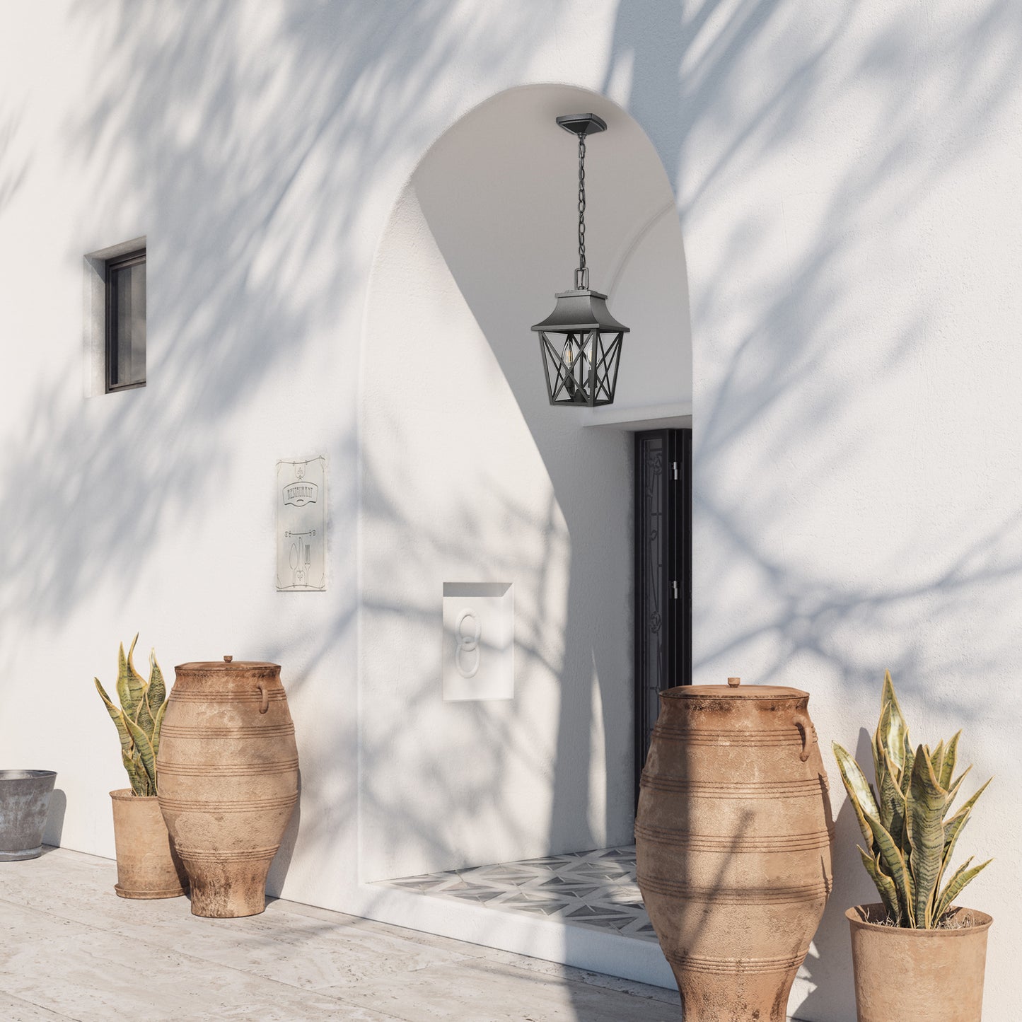 Black metal hanging lantern with glass panels and decorative chain