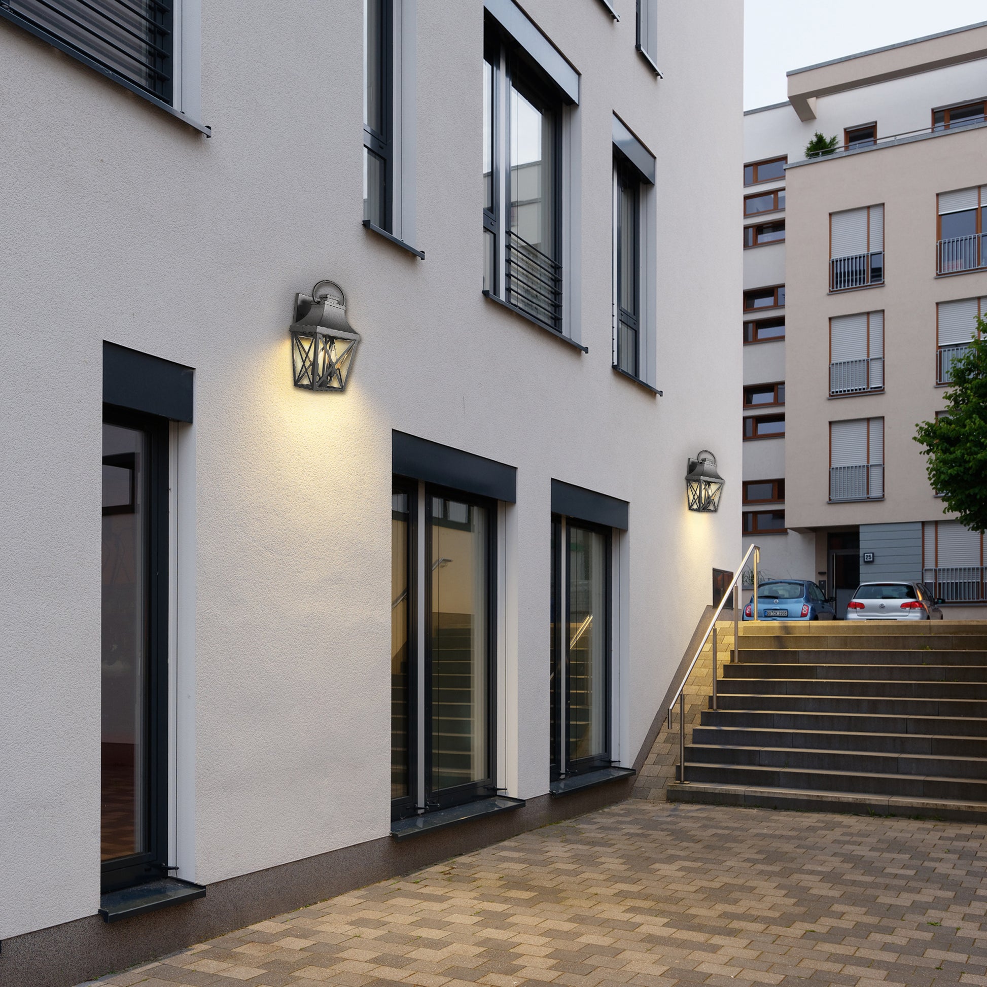 Black traditional lantern wall sconce with glass panels illuminating the exterior