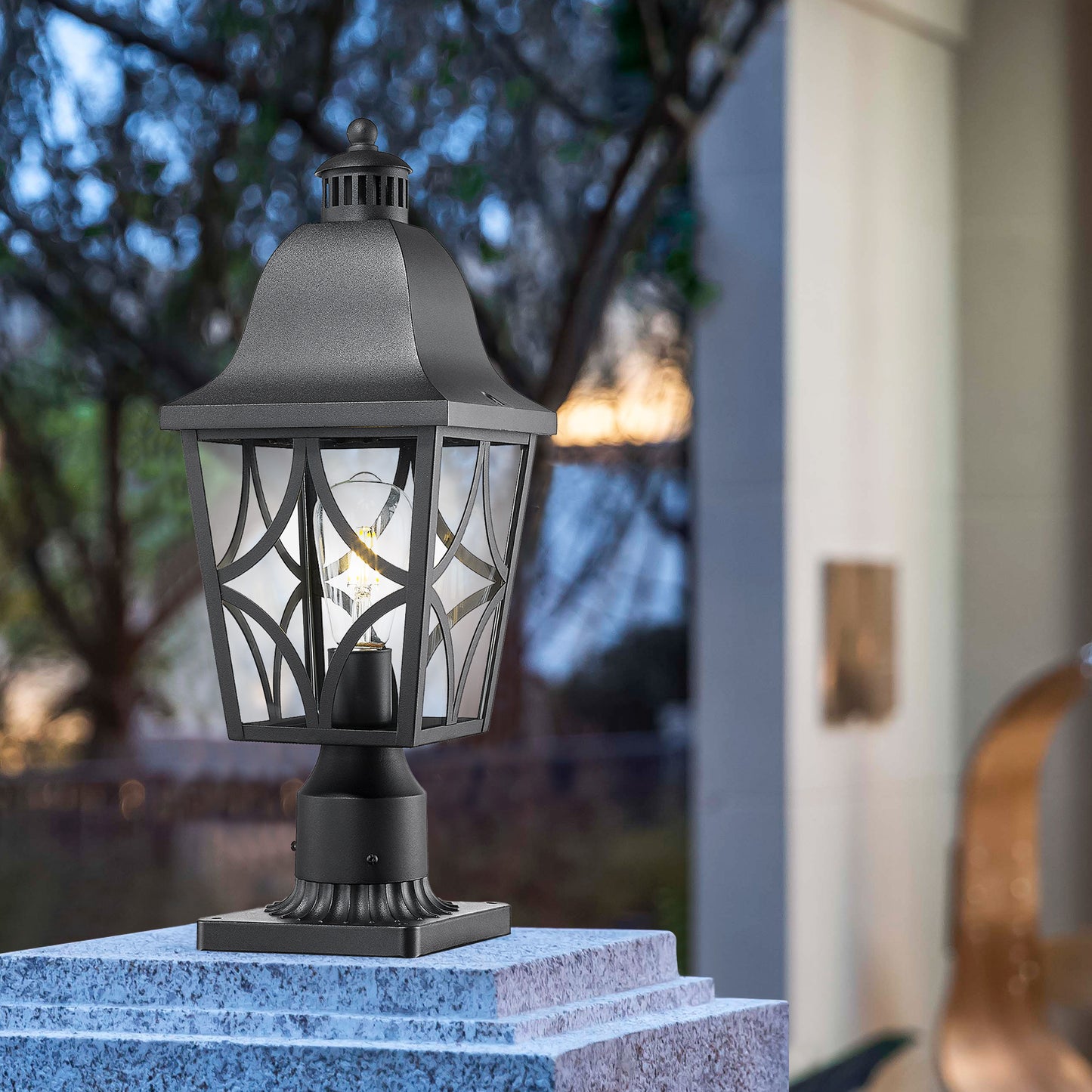 Black traditional post lantern with glass panes and decorative metal scrollwork