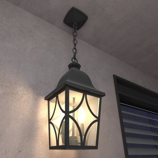 Black metal outdoor lantern with ornate glass panes