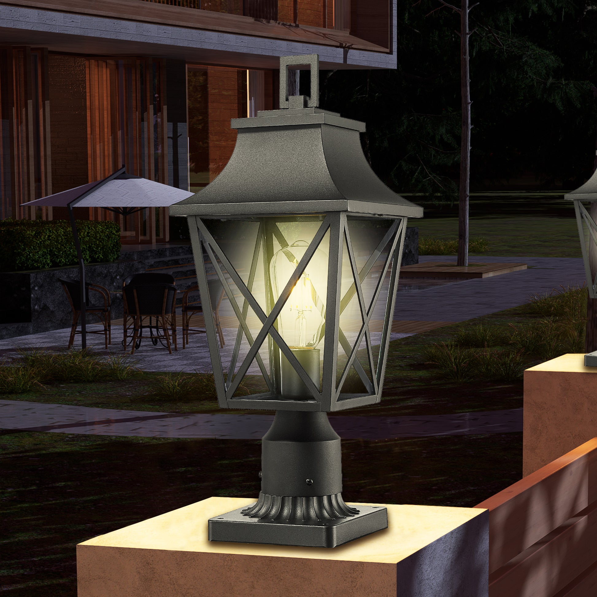 Classic black metal post lantern with clear Edison bulb illuminating outdoor pathway
