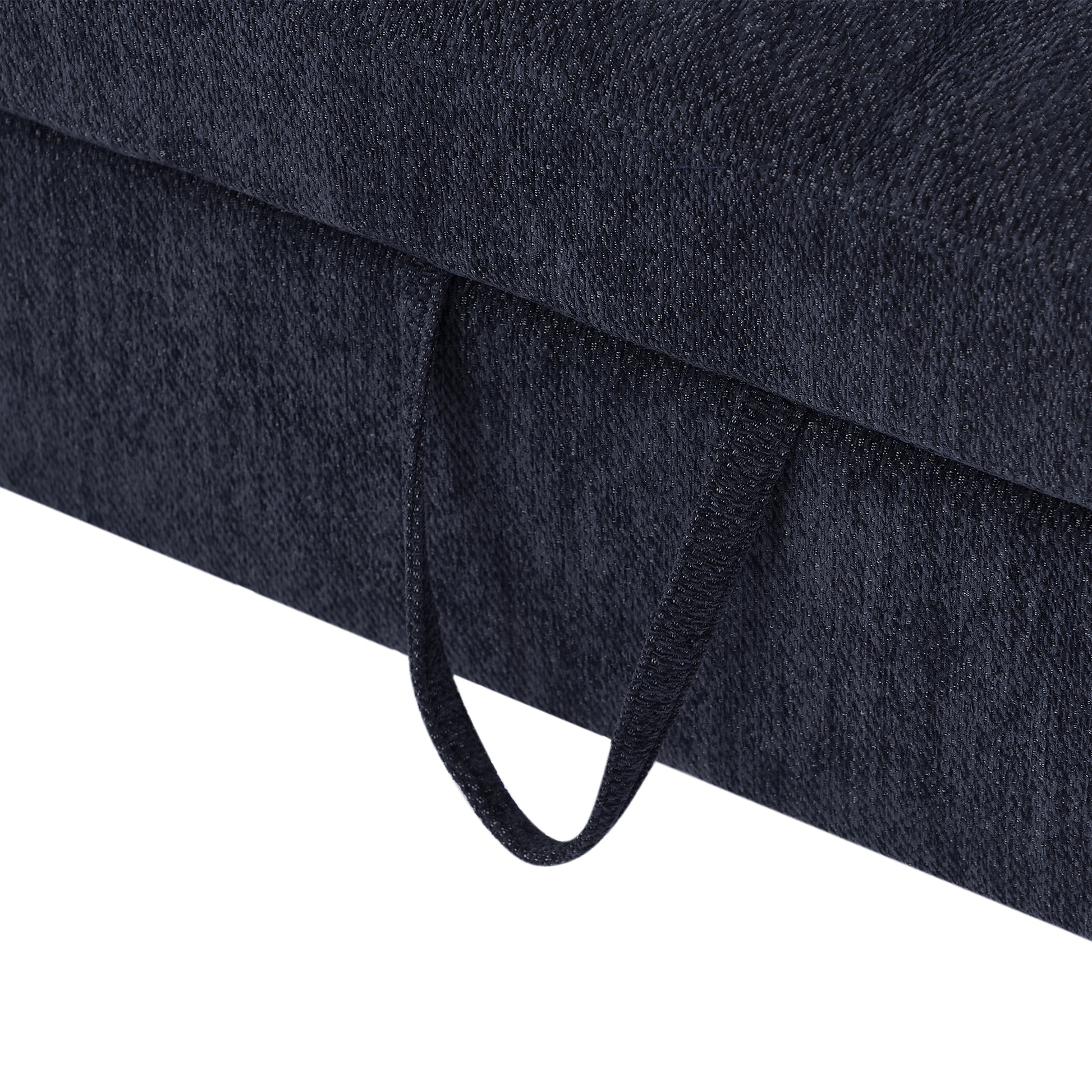 Dark navy textured fabric sofa detail with black pull tab