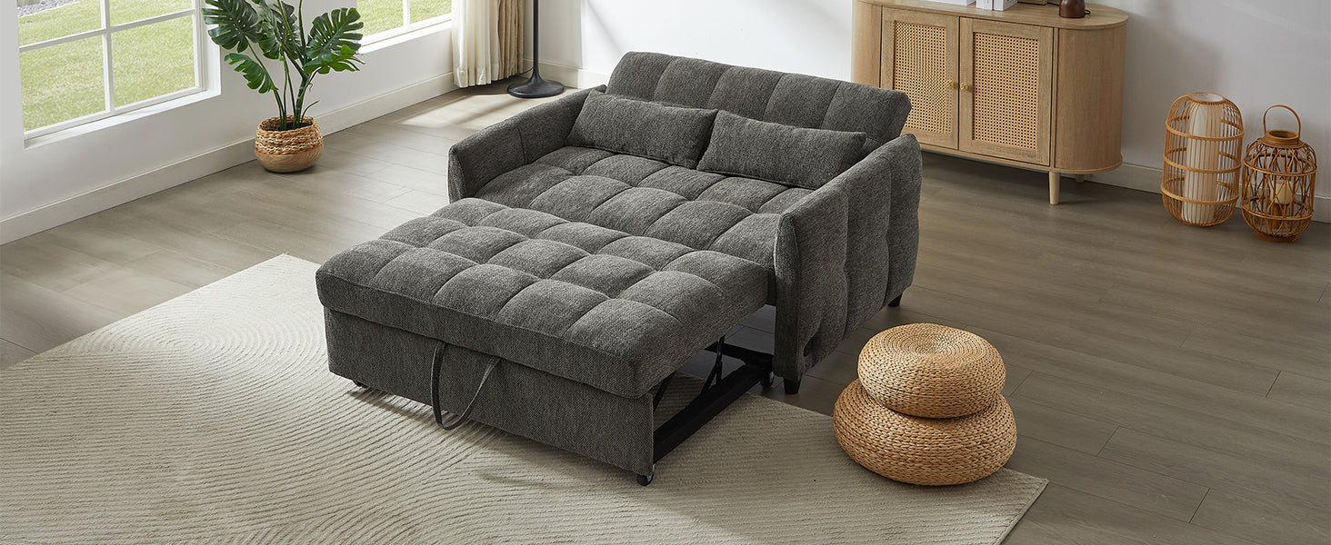 Grey upholstered sofa bed with tufted cushions and pullout ottoman