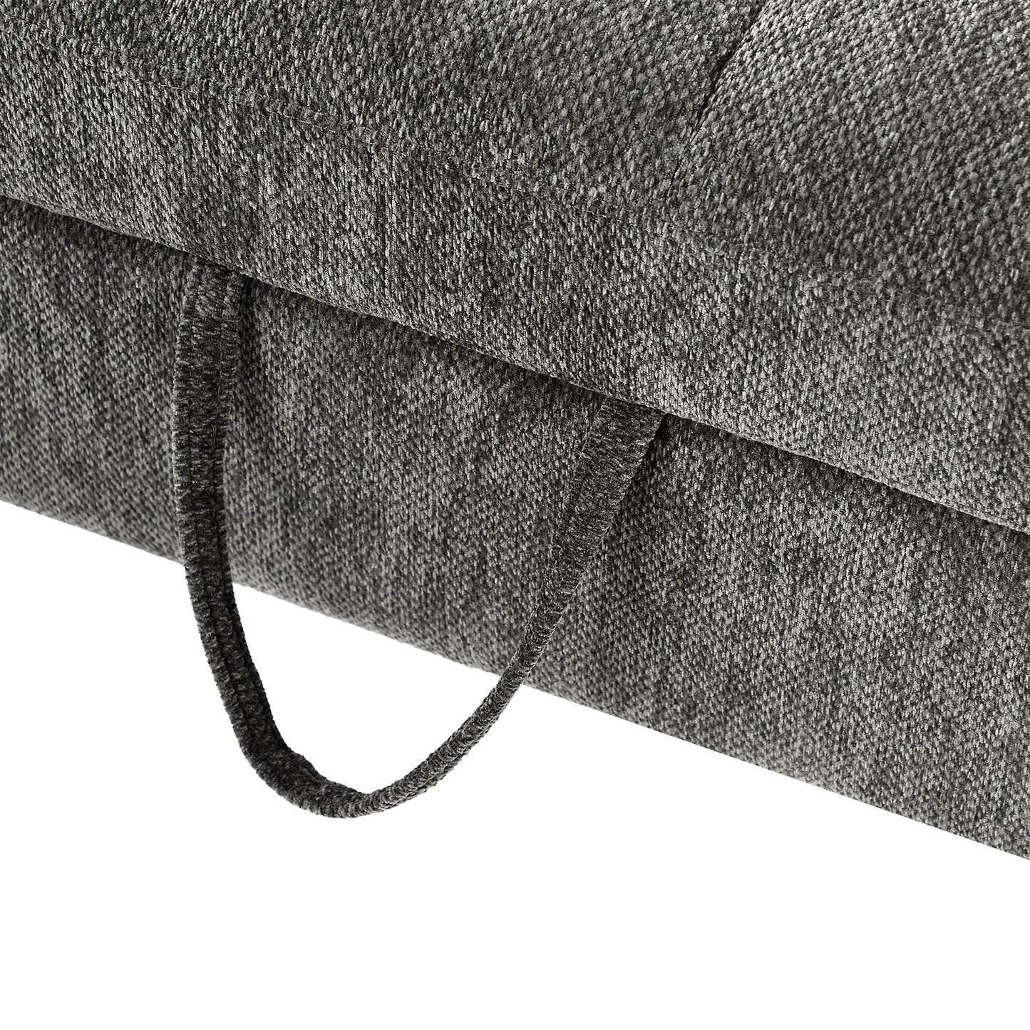 Closeup of textured charcoal grey fabric on a sofa cushion with a pull loop