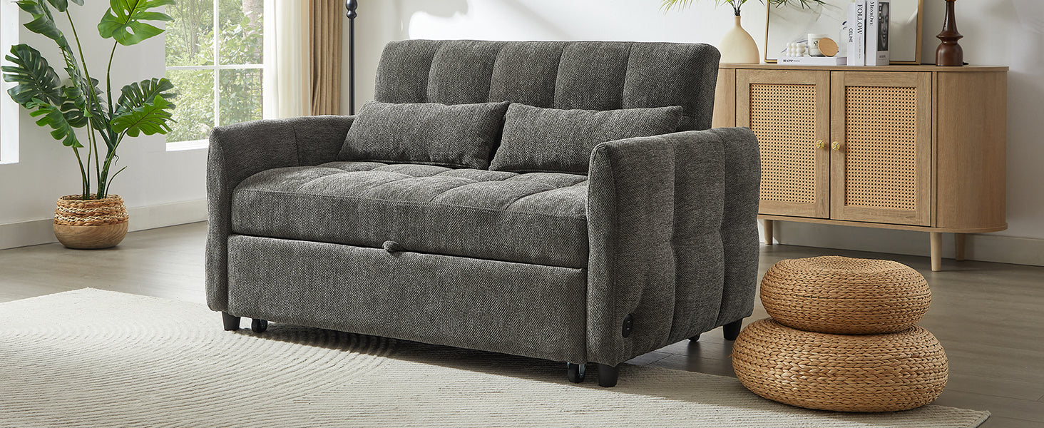 Dark gray upholstered sofa bed with tufted cushions and two lumbar pillows