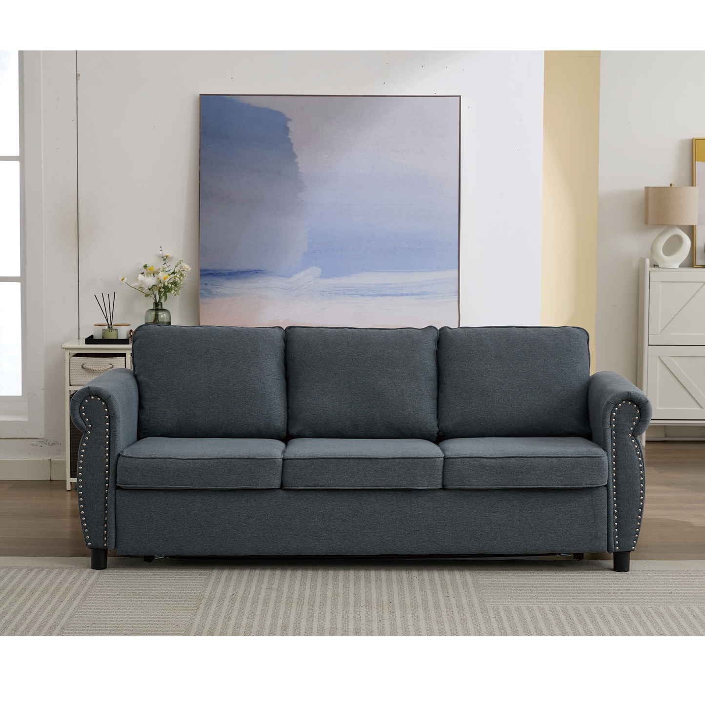 Threeseater navy blue fabric sofa with studded armrests