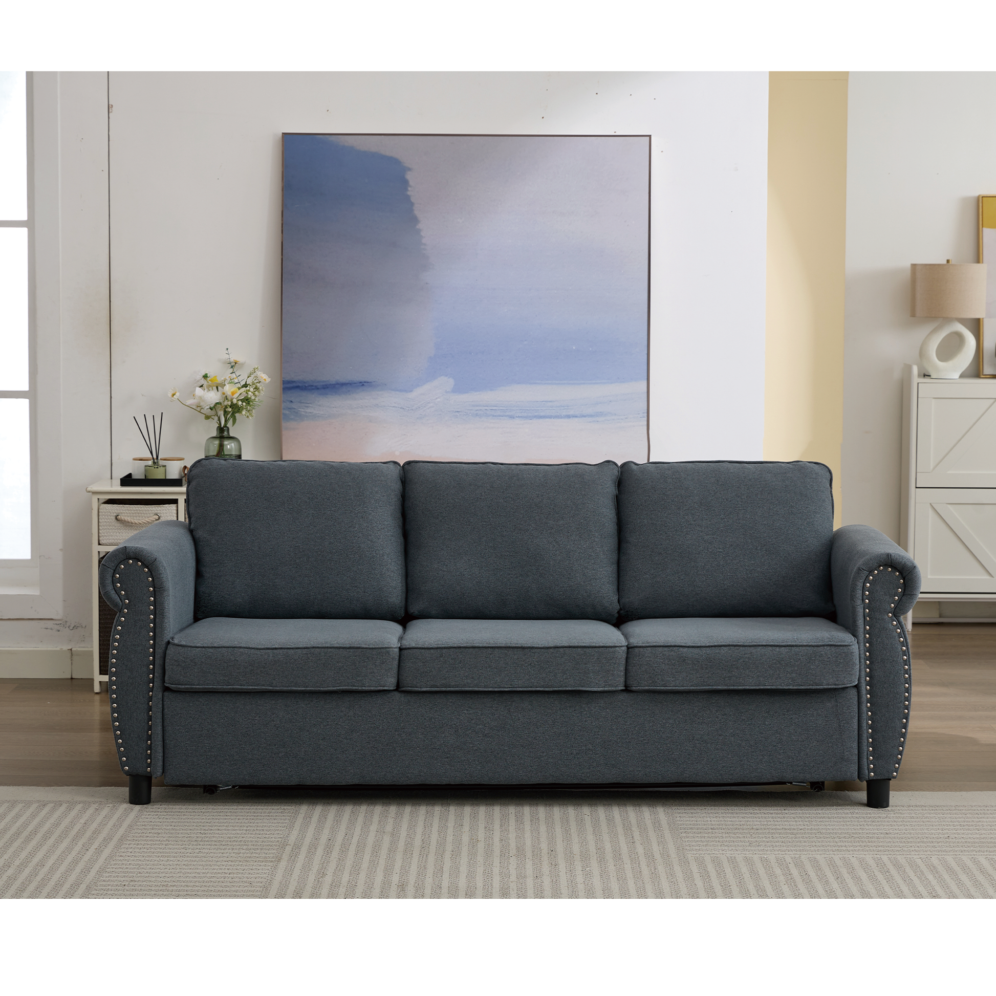 Threeseater navy blue fabric sofa with studded armrests