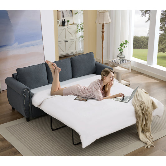 Dark grey fabric sofa bed with studded arms opened for sleeping