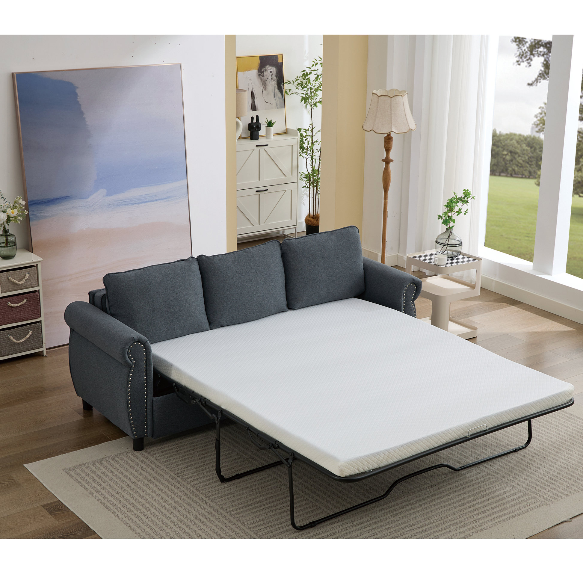 Dark grey fabric sofa bed with white mattress pulled out for sleeping