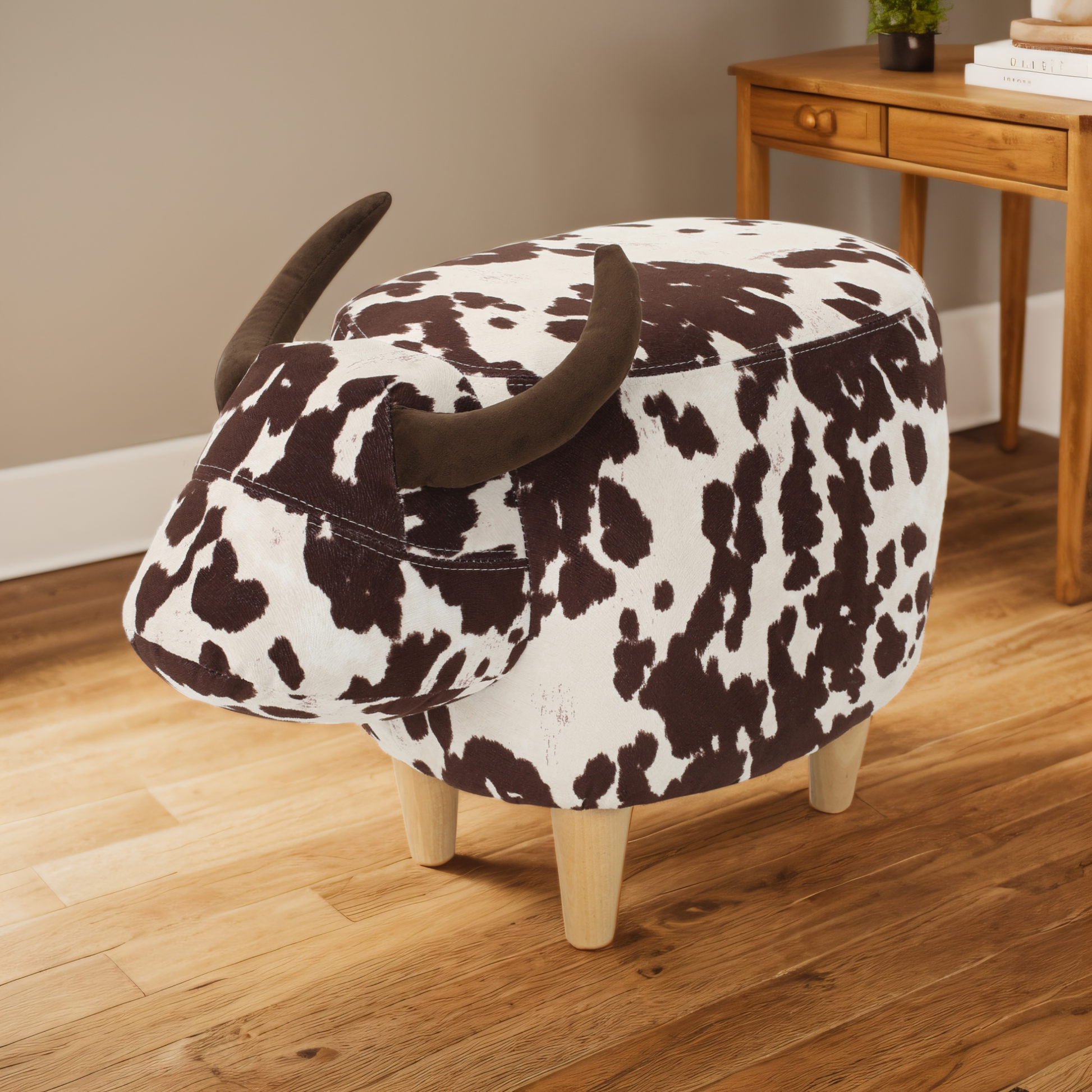 Brown and white cow print ottoman with short wooden legs