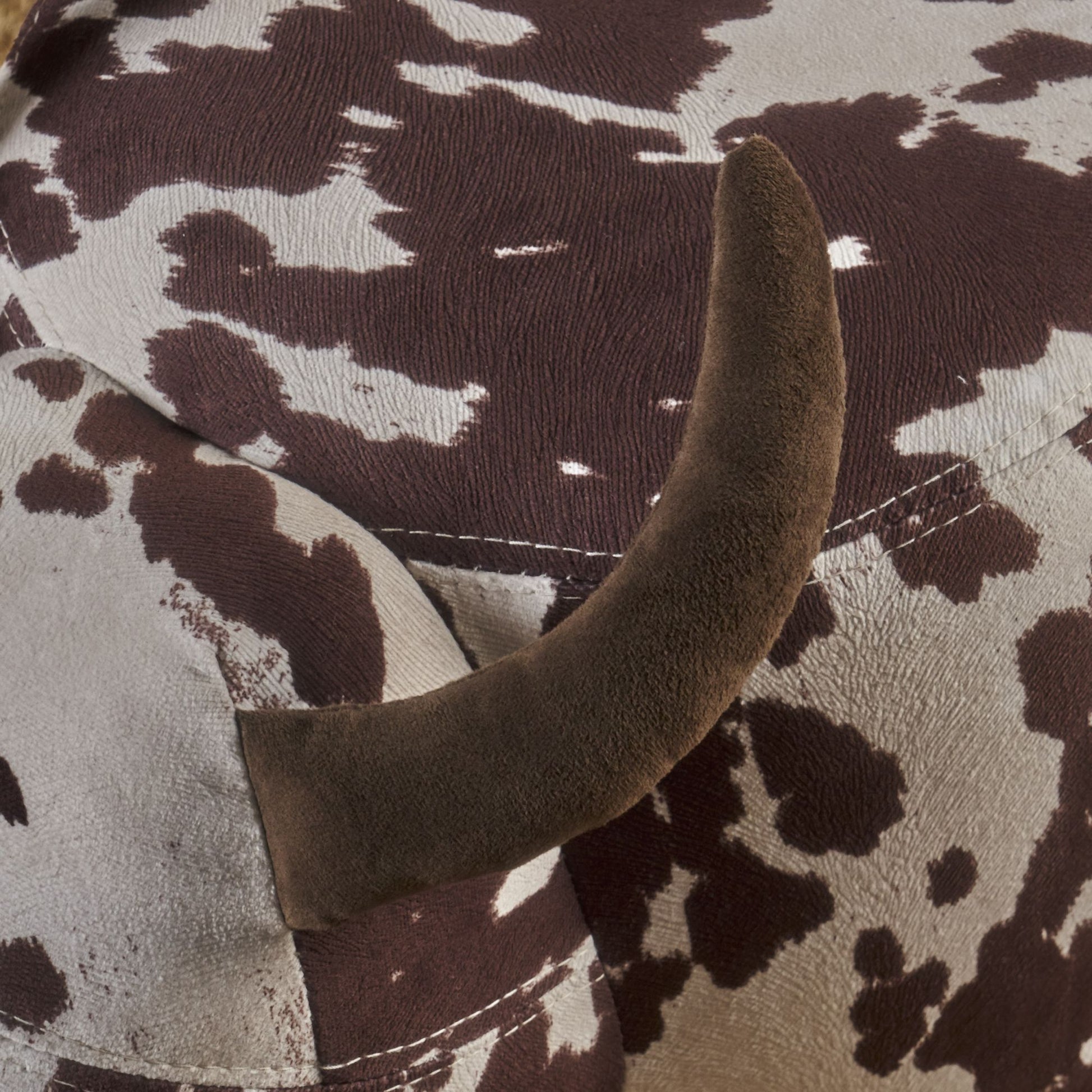 Brown and white cow print bean bag chair detail