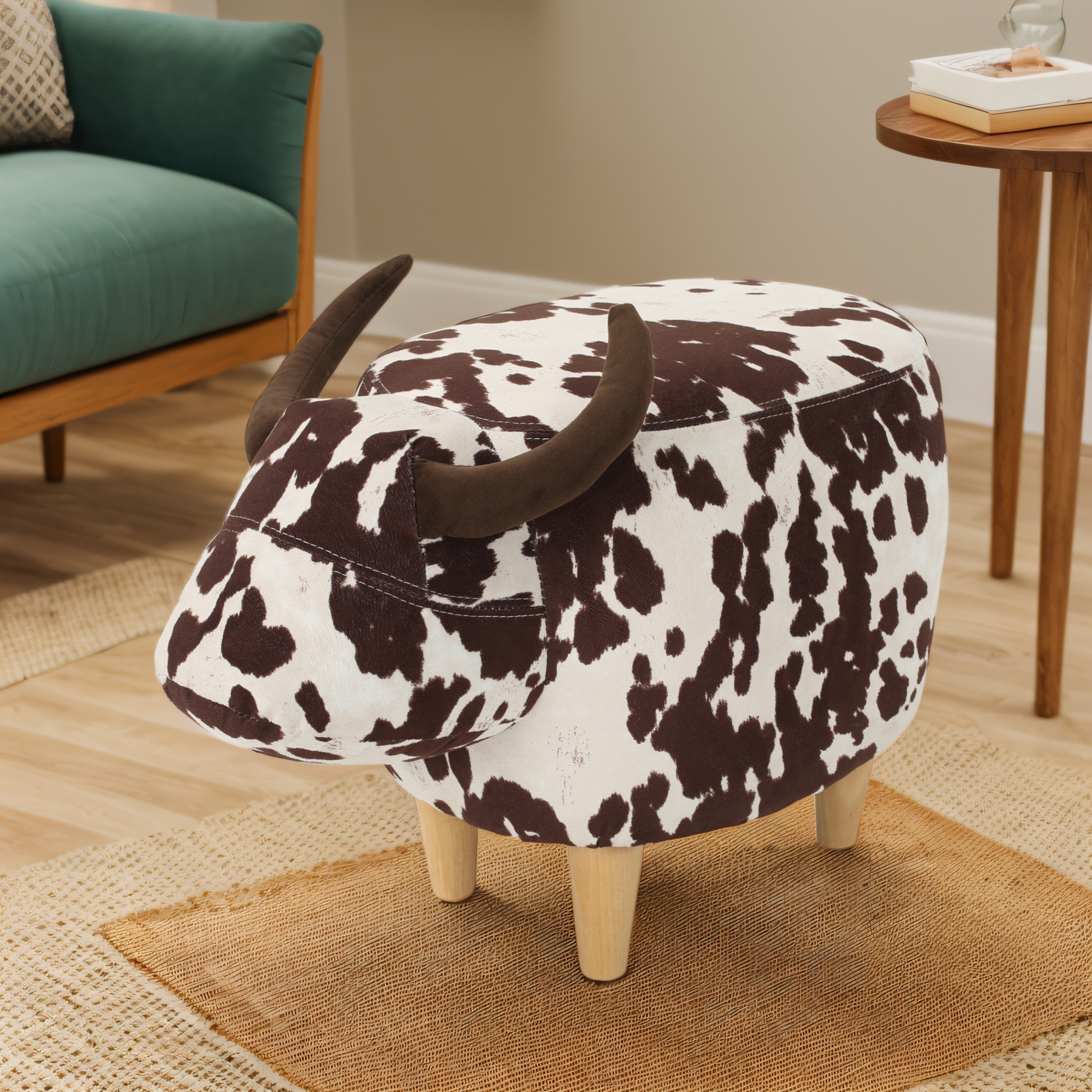 Cow print upholstered ottoman with horns and wooden legs