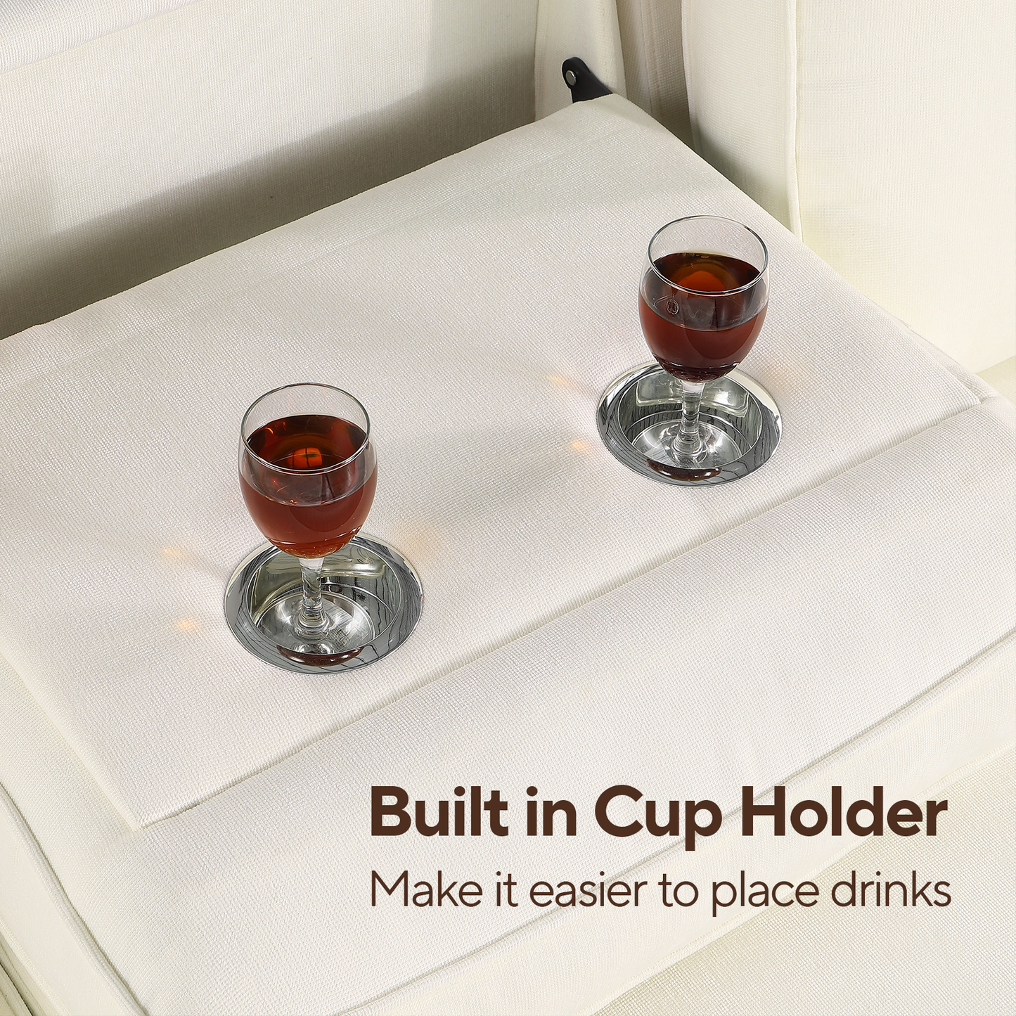 White sofa with builtin cup holder and two glasses of amber liquid