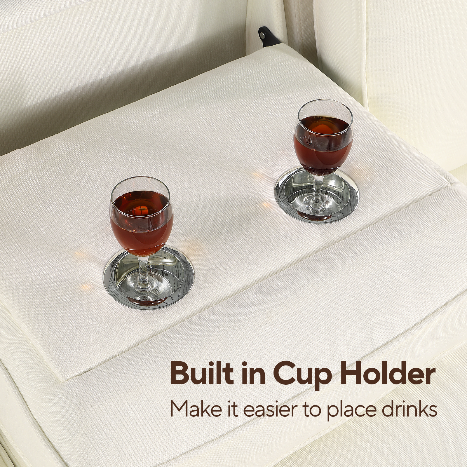 White sofa with builtin cup holder and two glasses of amber liquid