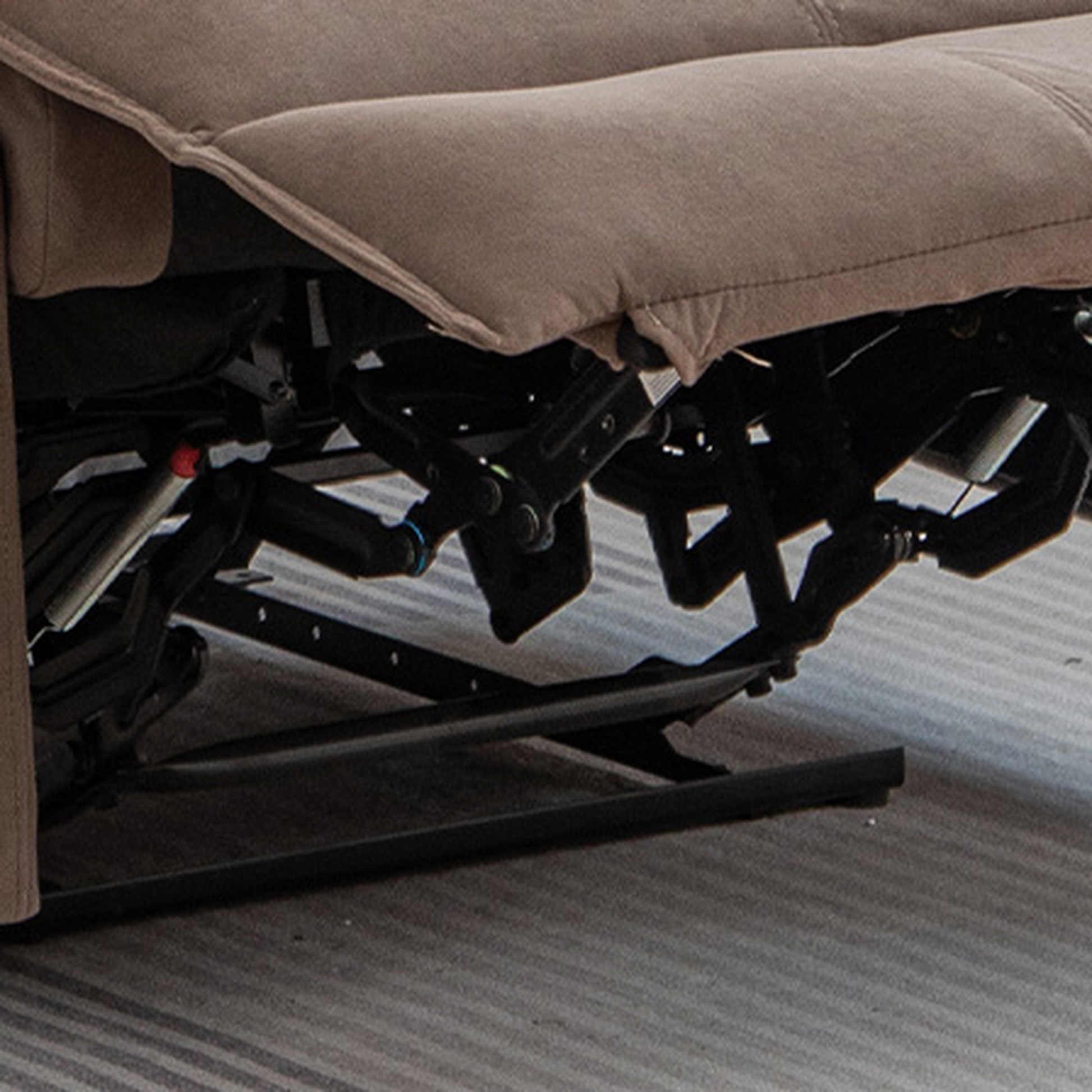 Brown fabric recliner chair mechanism with chrome accents for sturdy support and smooth operation