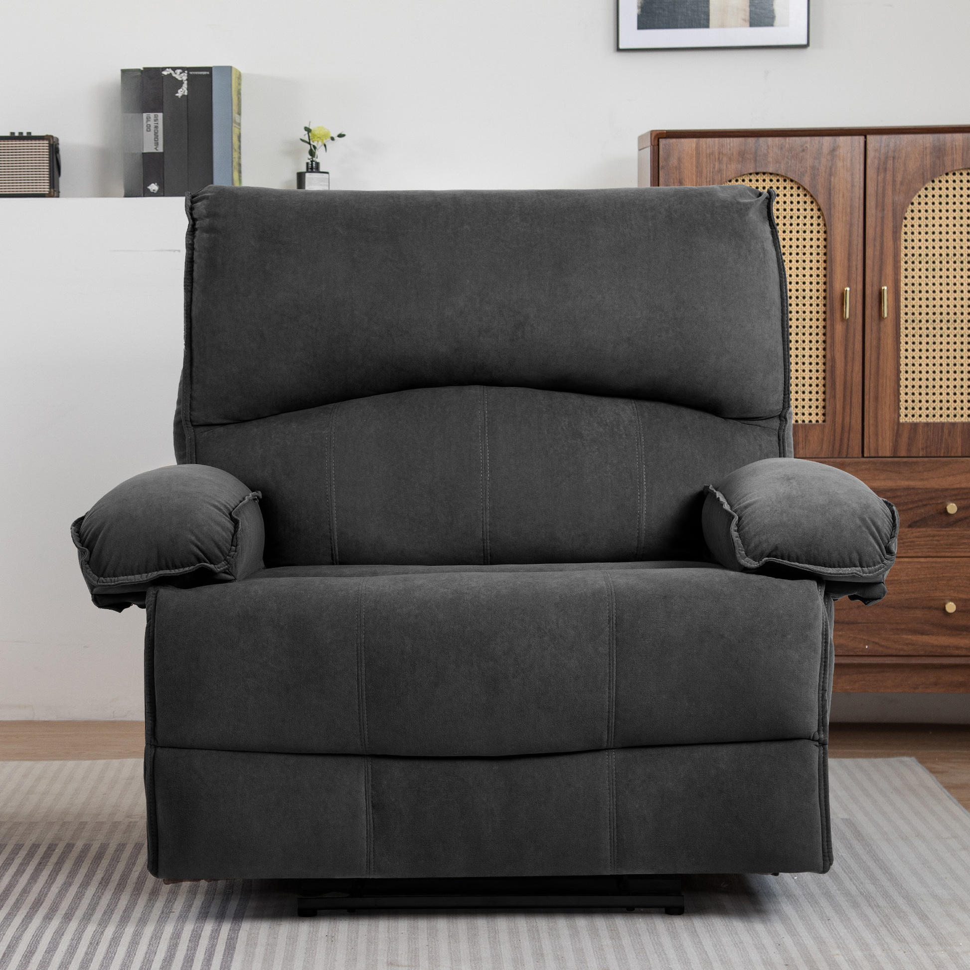 Plush dark gray fabric recliner chair with padded armrests and lumbar support
