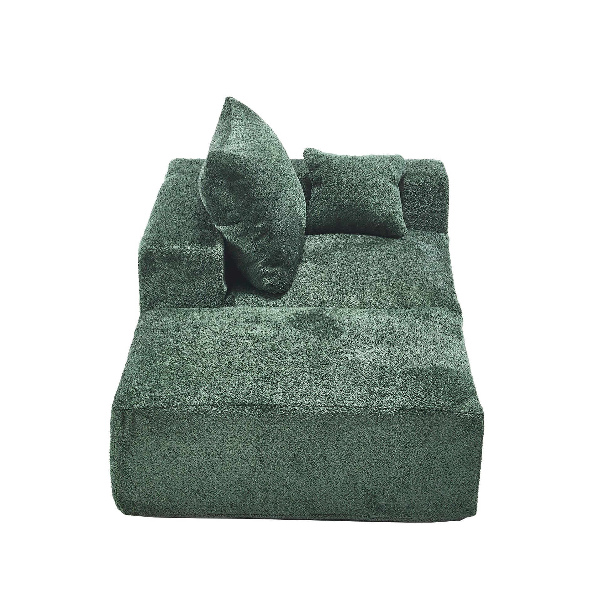 Plush emerald green velvet modular sofa with two accent pillows