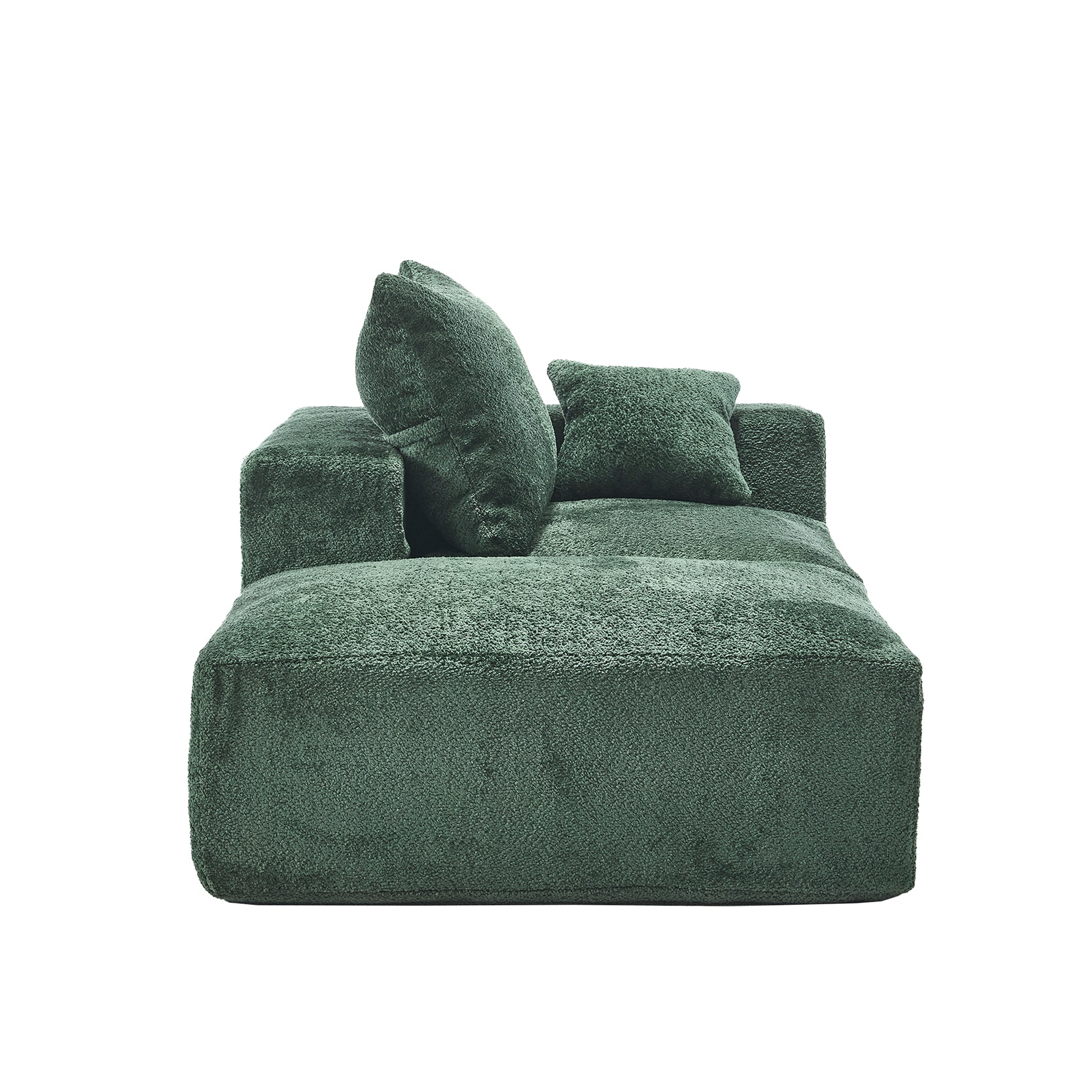 Plush green modular sofa with textured fabric and matching throw pillows