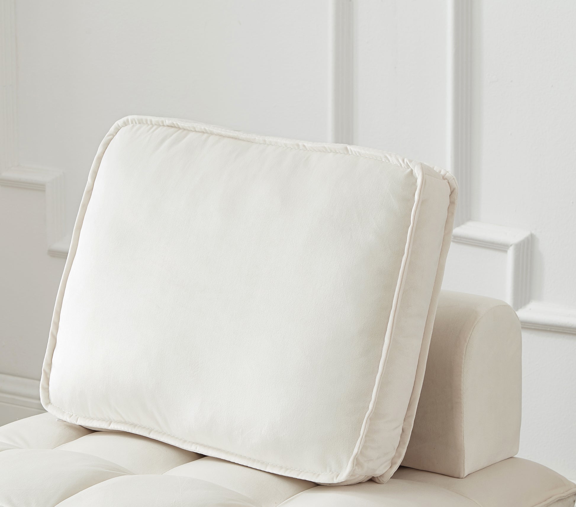 Cream velvet throw pillow with stitched piping detail