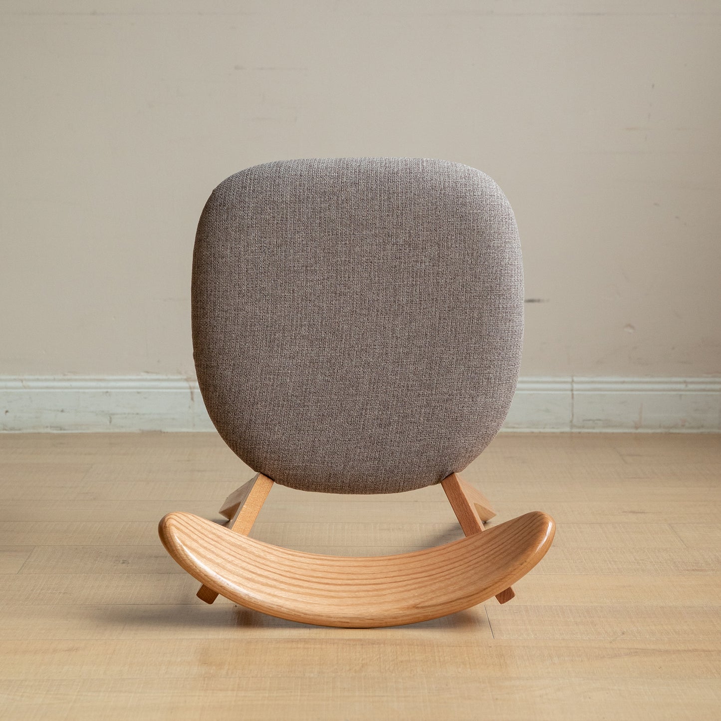 Gray fabric rocking chair with natural wood base