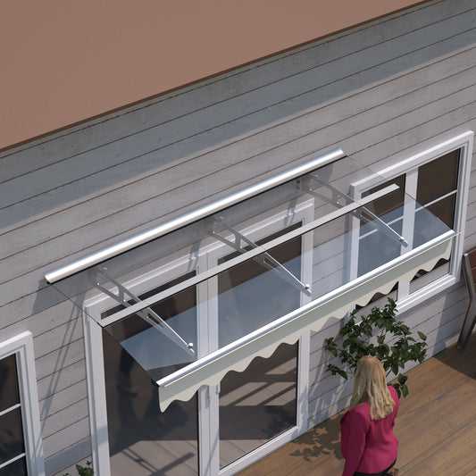 Modern glass awning with stainless steel supports protecting a double door
