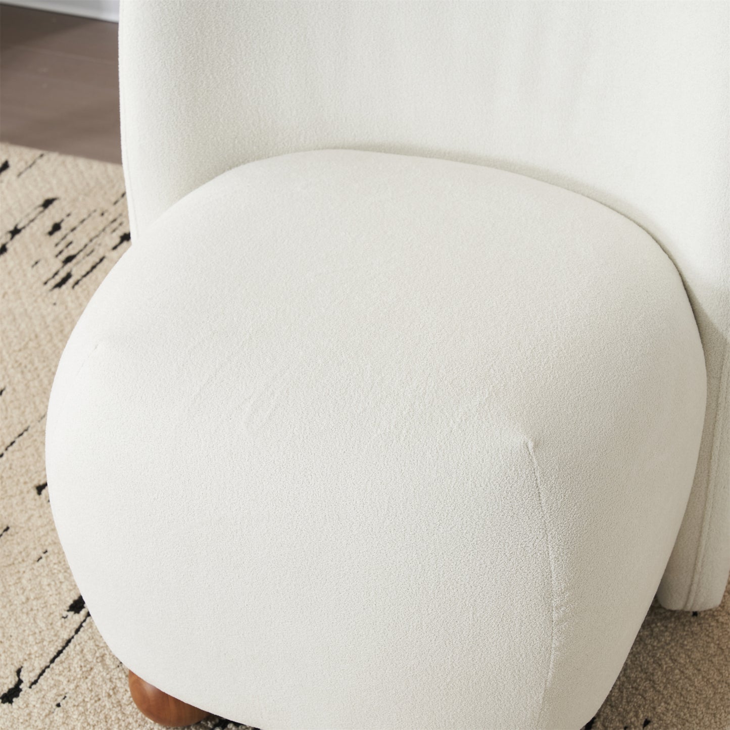 Textured cream boucle fabric armchair seat cushion detail