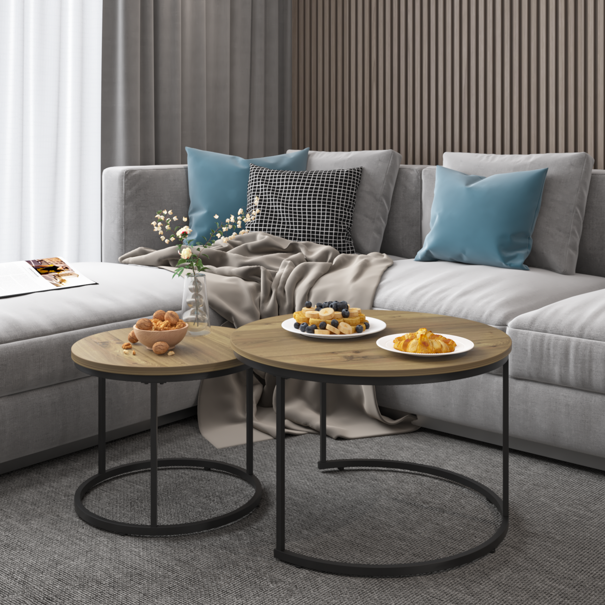 Round wood and metal nesting coffee tables with snacks and floral vase
