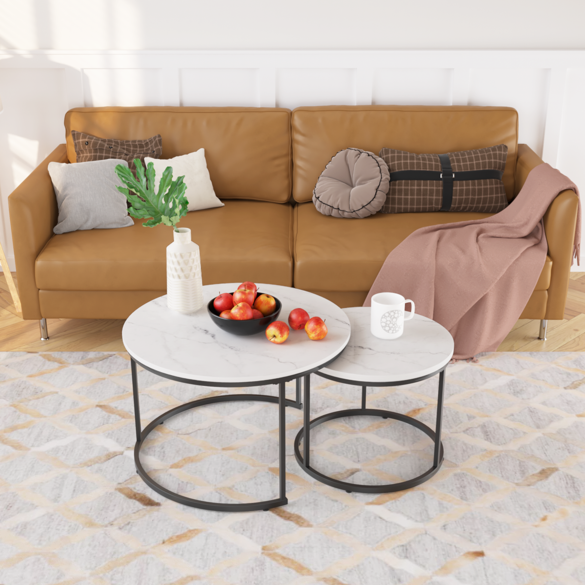 Tan leather sofa with scattered decorative pillows and a pink throw