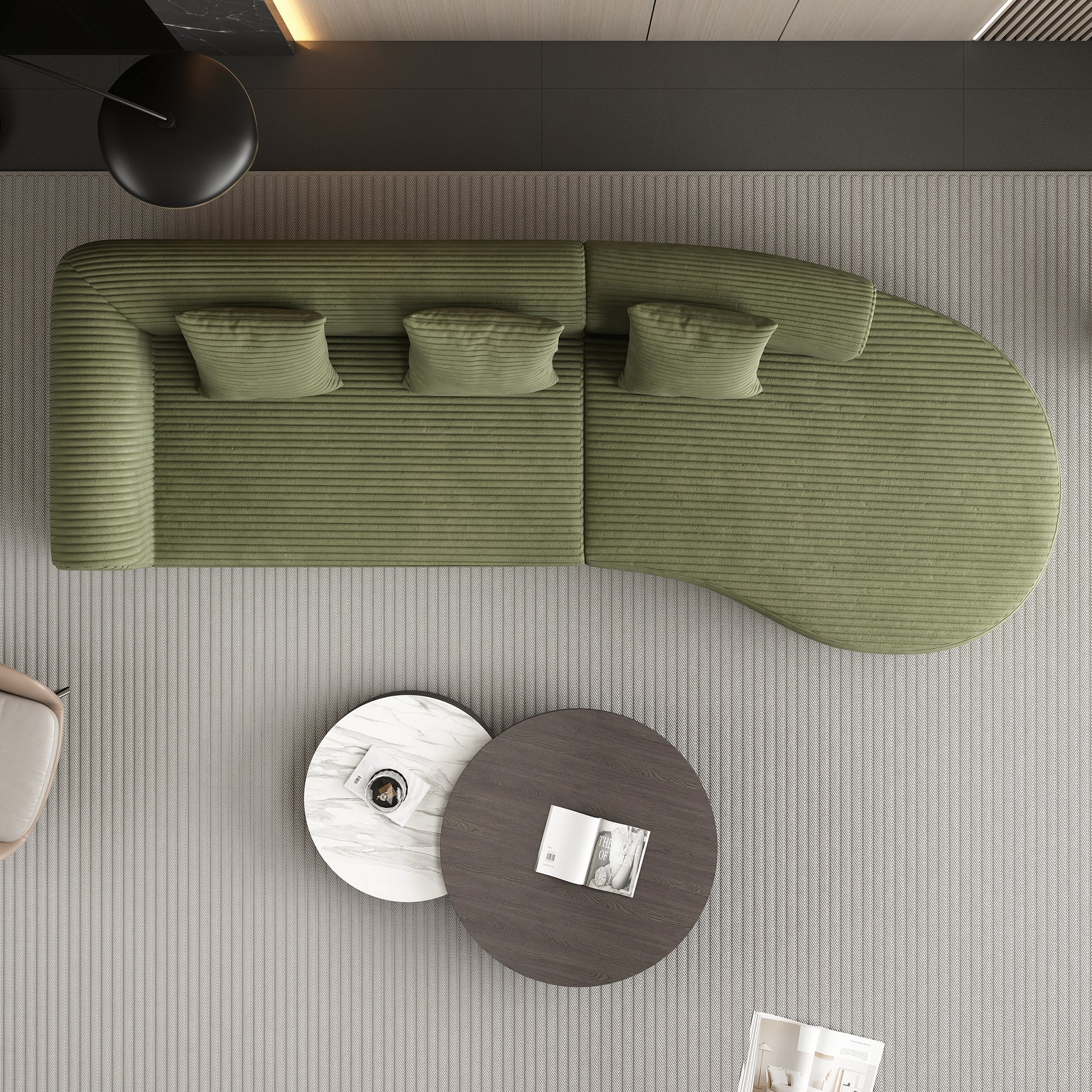 Green corduroy curved sectional sofa with throw pillows on a striped rug