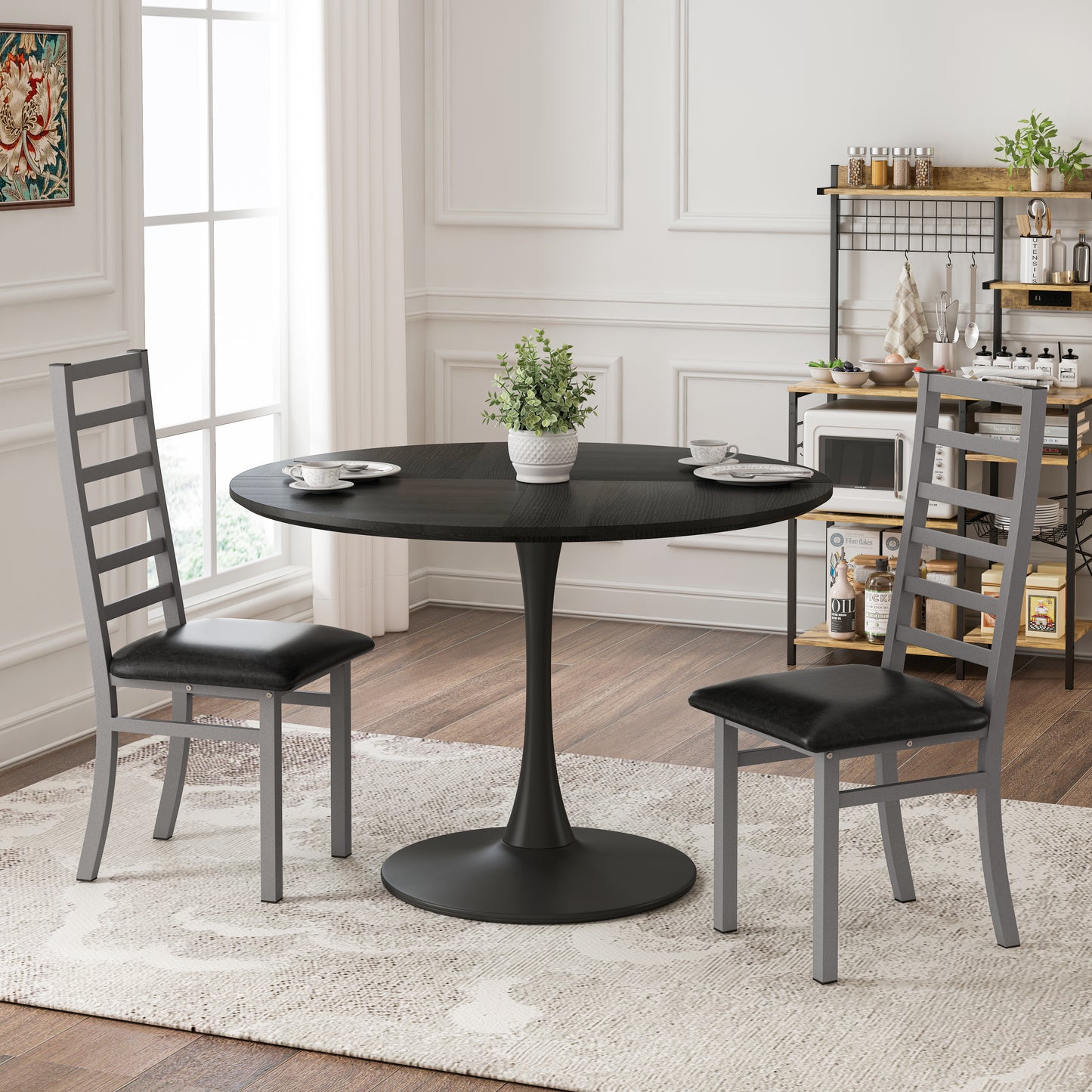 Black pedestal dining table with two modern grey chairs