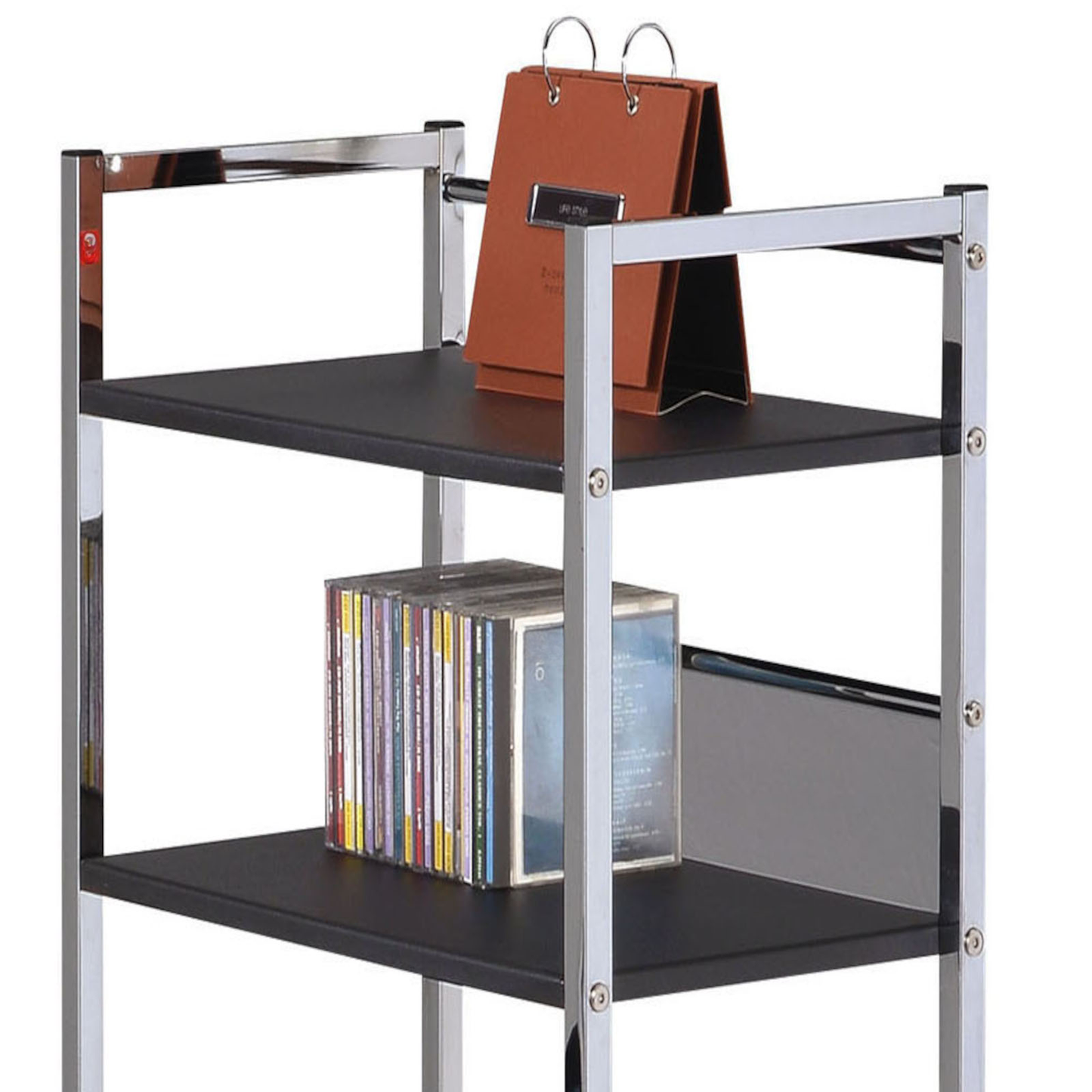 Chrome and black metal shelf unit with CDs and a desk calendar
