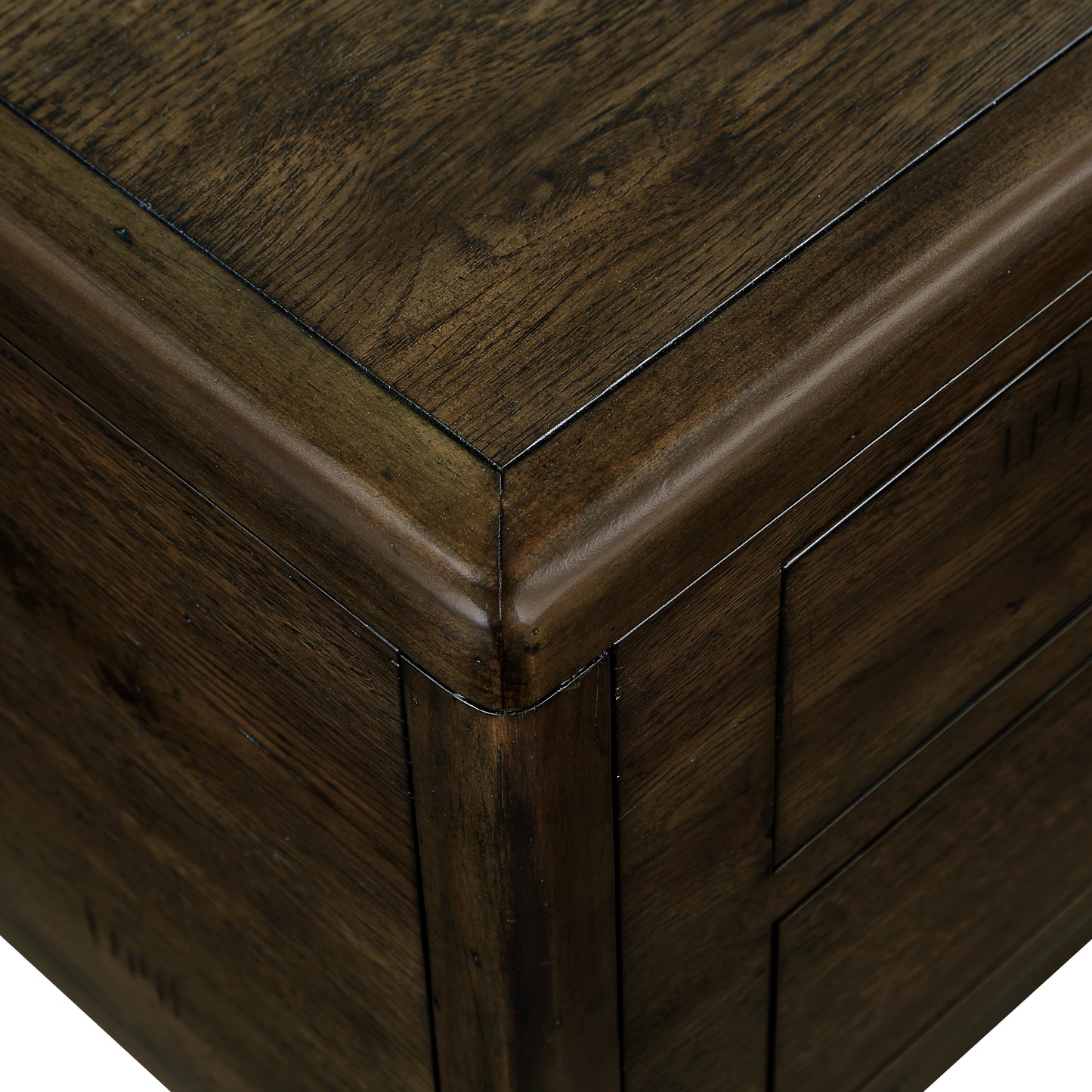 Dark walnut wood end table corner with carved detail