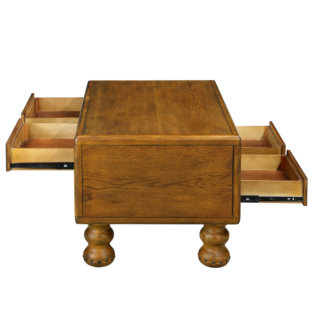 Rustic oak coffee table with four exposed drawers and turned legs