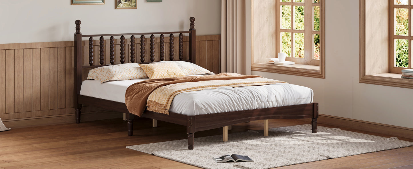 Dark wood spindle bed frame with white mattress and patterned pillows