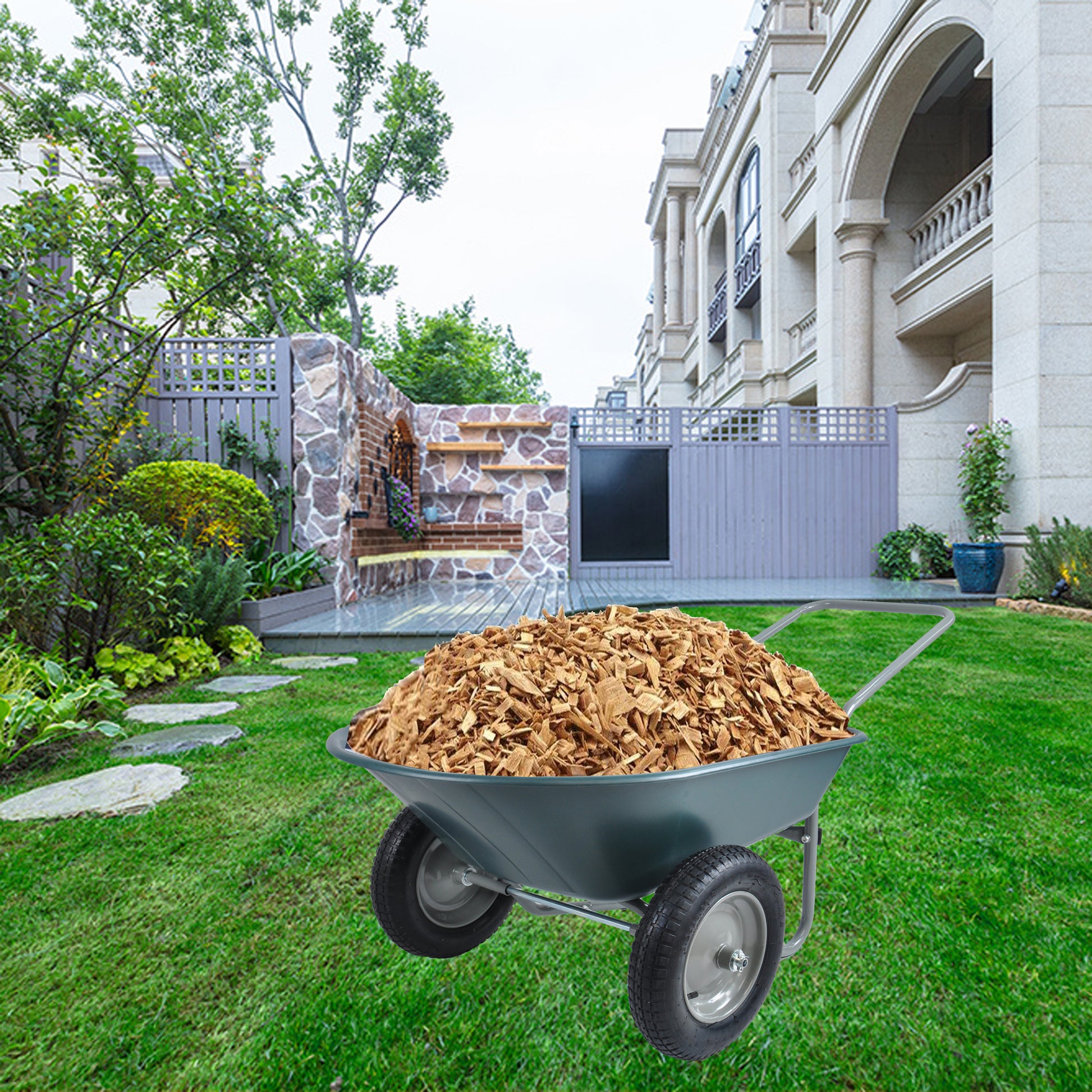 Grey garden wheelbarrow loaded with natural wood chips