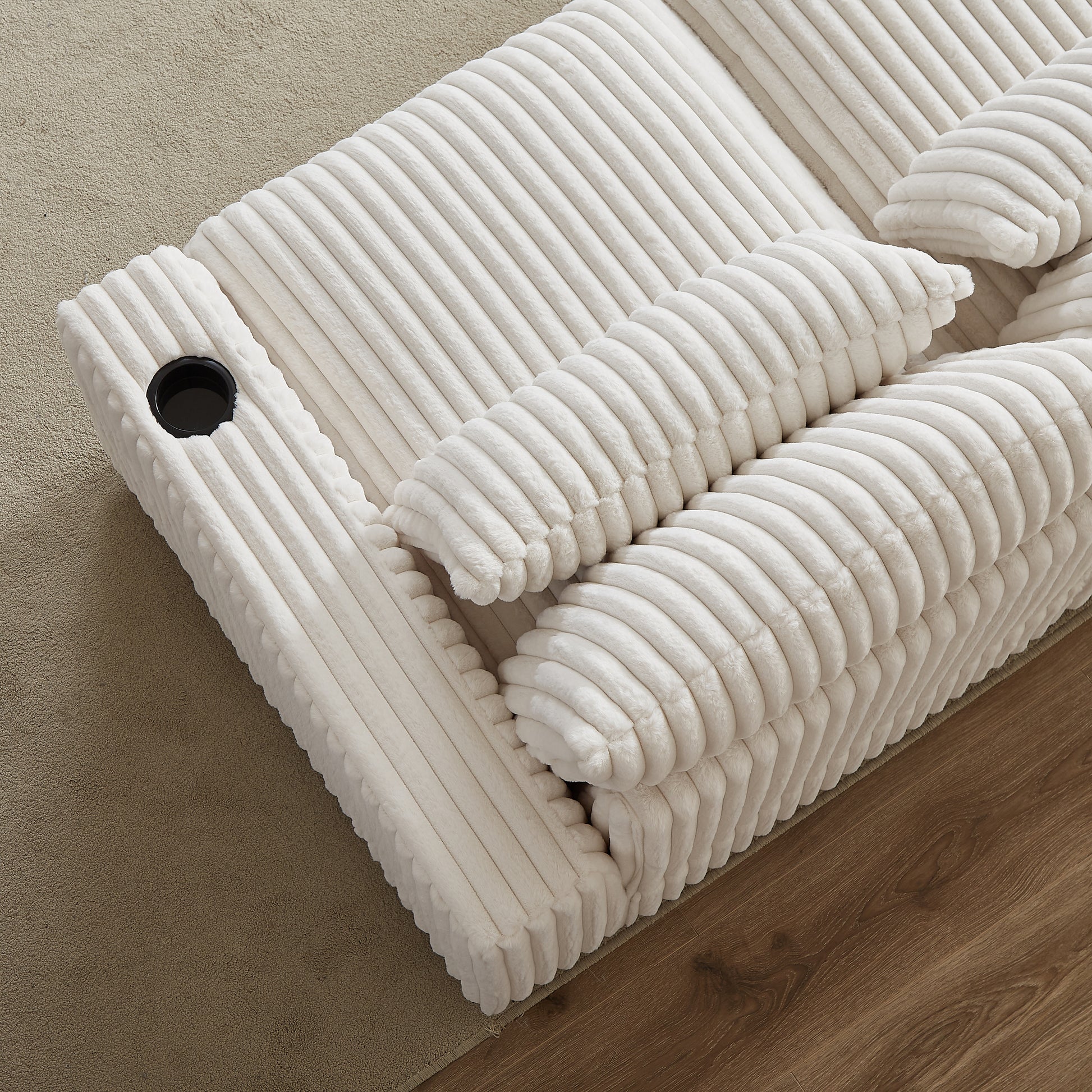 Plush white corduroy reclining sofa with builtin cup holder
