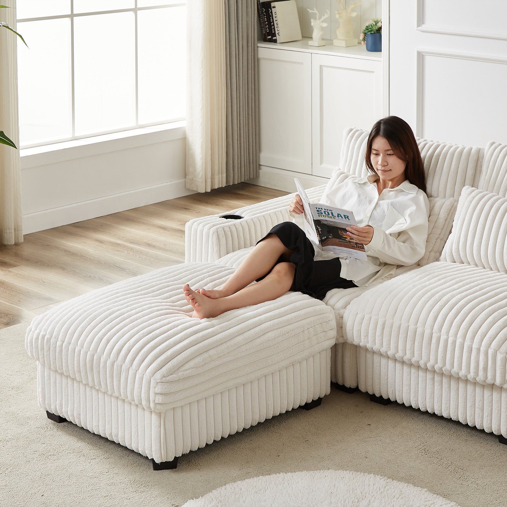 Plush white corduroy sectional sofa with chaise and ottoman